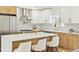 Modern kitchen featuring a large island with seating, stainless steel appliances, and white cabinetry with gold hardware at 2505 Upham St, Lakewood, CO 80214