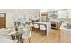 Bright open-concept space with a modern kitchen island, stainless steel appliances, and a connected living and dining area at 2505 Upham St, Lakewood, CO 80214