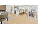 Spacious open-concept layout integrating the living room, kitchen island with seating, and a dining area for modern living at 2505 Upham St, Lakewood, CO 80214