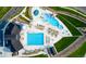 Stunning aerial view of the community pool and amenities, surrounded by lush landscaping and walkways at 7301 S Shady Grove Way, Aurora, CO 80016