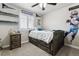 Cozy bedroom with a bed featuring built-in drawers, window, and team decor at 7301 S Shady Grove Way, Aurora, CO 80016