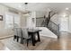 Formal dining room featuring a modern chandelier, staircase and natural light at 7301 S Shady Grove Way, Aurora, CO 80016