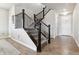 Inviting foyer with hardwood floors and a staircase with decorative wrought iron balusters at 7301 S Shady Grove Way, Aurora, CO 80016
