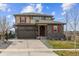 Charming two-story home featuring a two-car garage and a well-maintained front yard at 7301 S Shady Grove Way, Aurora, CO 80016