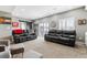 Spacious living room with neutral walls, carpet, barn door and comfortable oversized couches at 7301 S Shady Grove Way, Aurora, CO 80016