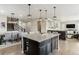 Open-concept living space featuring a dining area, kitchen island, staircase and adjacent living room at 7301 S Shady Grove Way, Aurora, CO 80016
