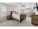 Serene main bedroom featuring a rustic wood bed frame, matching dresser, and bright natural light at 7301 S Shady Grove Way, Aurora, CO 80016