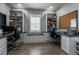 Well-lit office space with custom built-in shelving units and dual workstations at 7301 S Shady Grove Way, Aurora, CO 80016