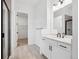 Bright bathroom featuring modern vanity, large mirror, and a glass enclosed shower at 6966 E 126Th Pl, Thornton, CO 80602