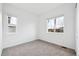 Bright, carpeted bedroom with two windows and a view of the neighborhood at 6966 E 126Th Pl, Thornton, CO 80602