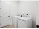 Modern laundry room with white washer and dryer, featuring sleek, minimalist design at 6966 E 126Th Pl, Thornton, CO 80602