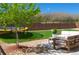 Spacious backyard featuring a cozy patio area with outdoor seating, a lush lawn, a trampoline, and beautiful landscaping at 7258 Oasis Dr, Castle Rock, CO 80108