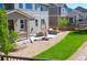 Expansive backyard with a stone patio, lush green lawn, and ample space for outdoor entertaining at 7258 Oasis Dr, Castle Rock, CO 80108