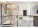 Modern bathroom featuring a tiled shower with glass enclosure and built-in bench seating, as well as a soaking tub at 7258 Oasis Dr, Castle Rock, CO 80108