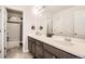 Modern bathroom featuring a double vanity, neutral color palette, and an adjacent shower-tub combination at 7258 Oasis Dr, Castle Rock, CO 80108