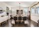 A stylish dining room features a large table, chandelier, and dark hardwood floors at 7258 Oasis Dr, Castle Rock, CO 80108