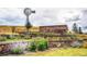 Cobblestone Ranch entrance sign set amid lush landscaping and a windmill feature at 7258 Oasis Dr, Castle Rock, CO 80108