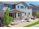 Charming exterior view of a two-story home with a porch, patio, and manicured backyard at 7258 Oasis Dr, Castle Rock, CO 80108
