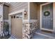 A detailed view of the front entrance, stone accents, and a welcoming wreath at 7258 Oasis Dr, Castle Rock, CO 80108