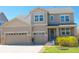 Charming two-story home with a two-car garage and a welcoming front porch, featuring beautiful stone accents and a well-manicured lawn at 7258 Oasis Dr, Castle Rock, CO 80108