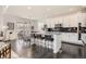 Modern kitchen with granite countertops, sleek black backsplash, and a breakfast bar at 7258 Oasis Dr, Castle Rock, CO 80108