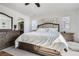 Spacious main bedroom featuring plush bedding, stylish decor, and a doorway leading to the ensuite bathroom at 7258 Oasis Dr, Castle Rock, CO 80108