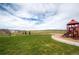 Community playground with play structure surrounded by green space and open fields at 7258 Oasis Dr, Castle Rock, CO 80108