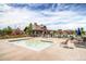 Beautiful community pool with chairs, tables, umbrellas, playset, and clubhouse at 7258 Oasis Dr, Castle Rock, CO 80108