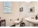 Cozy powder room with a pedestal sink, sleek fixtures, and modern decor at 7258 Oasis Dr, Castle Rock, CO 80108