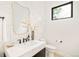 Elegant powder room featuring stylish fixtures, sleek mirror, patterned tile, and contemporary design at 2773 S Garfield St, Denver, CO 80210