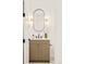 Elegant powder room with sleek vanity, lighting, oval mirror and modern fixtures at 2773 S Garfield St, Denver, CO 80210
