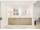 Bright bathroom with double vanity, modern lighting fixtures, and marble-patterned flooring at 2773 S Garfield St, Denver, CO 80210