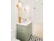 Stylish bathroom boasts a green vanity, gold fixtures, a mirror, and decorative tile flooring at 2773 S Garfield St, Denver, CO 80210