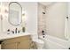 Stylish bathroom featuring a modern vanity, lighting, and tub with black matte fixtures at 2773 S Garfield St, Denver, CO 80210