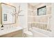 Tiled bathroom area with a bathtub and stylish mirror above a sink and vanity at 2773 S Garfield St, Denver, CO 80210