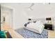 Bright bedroom boasts a geometric rug, ceiling fan, and neutral-toned walls and decor at 2773 S Garfield St, Denver, CO 80210