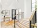 Bright foyer boasts hardwood floors, modern railing, and an open entryway with lots of natural light at 2773 S Garfield St, Denver, CO 80210
