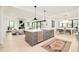 Open-concept kitchen with stainless steel appliances, a spacious island, and seamless flow to living and dining areas at 2773 S Garfield St, Denver, CO 80210