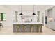 Bright kitchen featuring a large island with bar seating, modern lighting, and a marble backsplash at 2773 S Garfield St, Denver, CO 80210