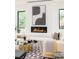 Bright living room showcases a modern fireplace and floor-to-ceiling windows, enhancing the space at 2773 S Garfield St, Denver, CO 80210