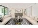 Expansive living room and kitchen features hardwood floors and ample natural light, seamlessly connected at 2773 S Garfield St, Denver, CO 80210