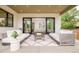 Covered patio includes comfortable seating and offers a view into the bright and open living room at 2773 S Garfield St, Denver, CO 80210