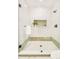 Modern shower with sleek black fixtures, glass door, and mosaic tile featuring a decorative inset shelf at 2773 S Garfield St, Denver, CO 80210