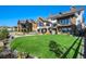 Large backyard with lush lawn and multiple homes at 2599 Heron Lakes Pkwy, Berthoud, CO 80513