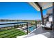 Stunning balcony view overlooking lake, pool, and landscaped grounds at 2599 Heron Lakes Pkwy, Berthoud, CO 80513