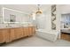 Spa-like bathroom with double vanity and a large mirror at 2599 Heron Lakes Pkwy, Berthoud, CO 80513