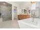 Luxurious bathroom with a soaking tub and walk-in shower at 2599 Heron Lakes Pkwy, Berthoud, CO 80513