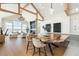 Open concept dining area with a large live-edge table and modern chairs at 2599 Heron Lakes Pkwy, Berthoud, CO 80513