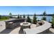 Stone fire pit with seating area and lake view at 2599 Heron Lakes Pkwy, Berthoud, CO 80513