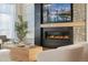 Modern fireplace with built-in TV and stone accents at 2599 Heron Lakes Pkwy, Berthoud, CO 80513